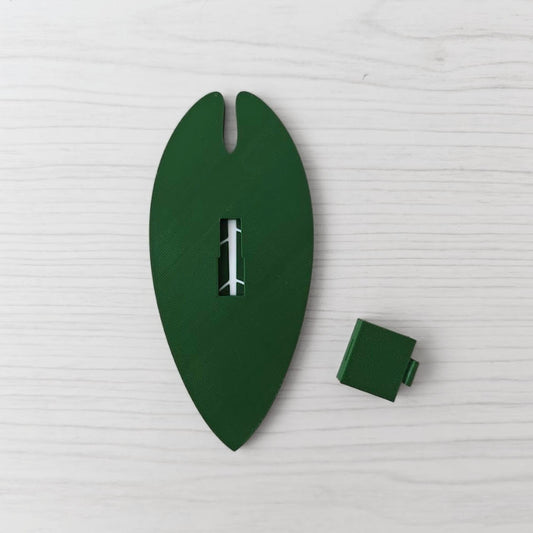 Back view of the handle with the separate green cover piece placed beside it.