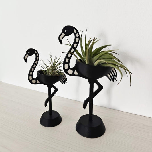 Pair of skeleton flamingo Tillandsia holders shown at an angle, highlighting size difference