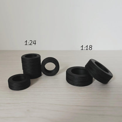 Miniature tires displayed in 1:24 and 1:18 scale side by side