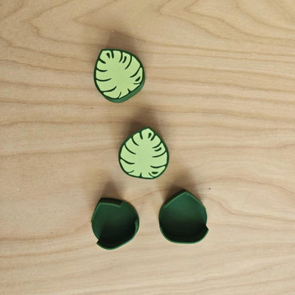 Close-up of green monstera cable clips
