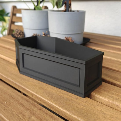 Empty coffin planter on table, decorative gothic plant container