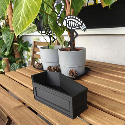 Coffin planter styled with plants on shelf, gothic indoor plant decor