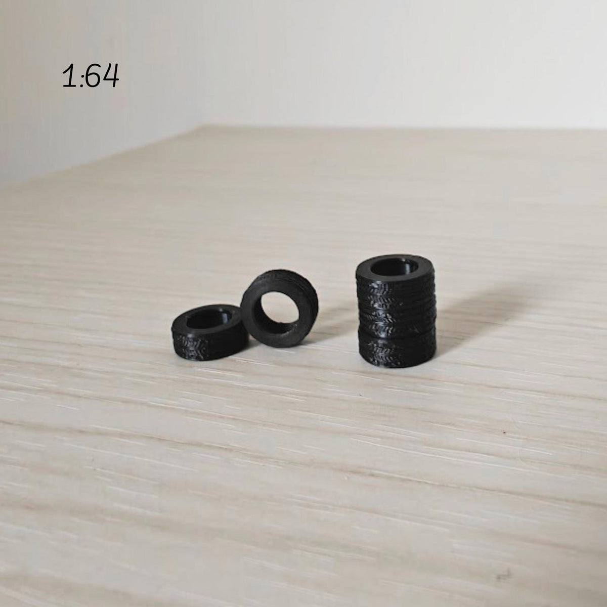 1:64 scale miniature tires grouped together showing smallest size option