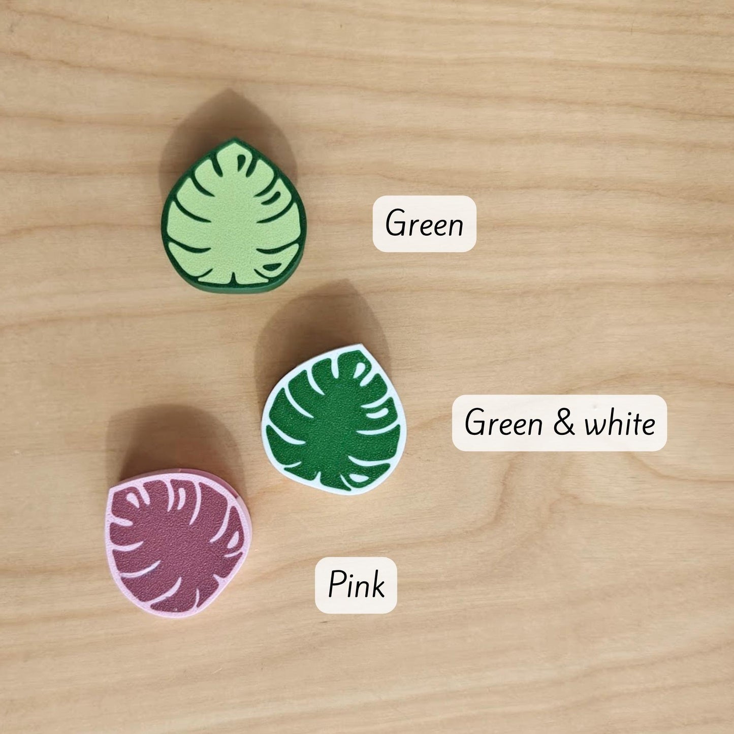 Monstera cable clip color options shown in green, green and white, and pink
