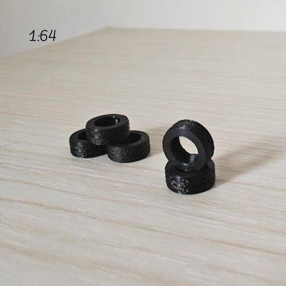 1:64 scale miniature tires grouped together showing smallest size option