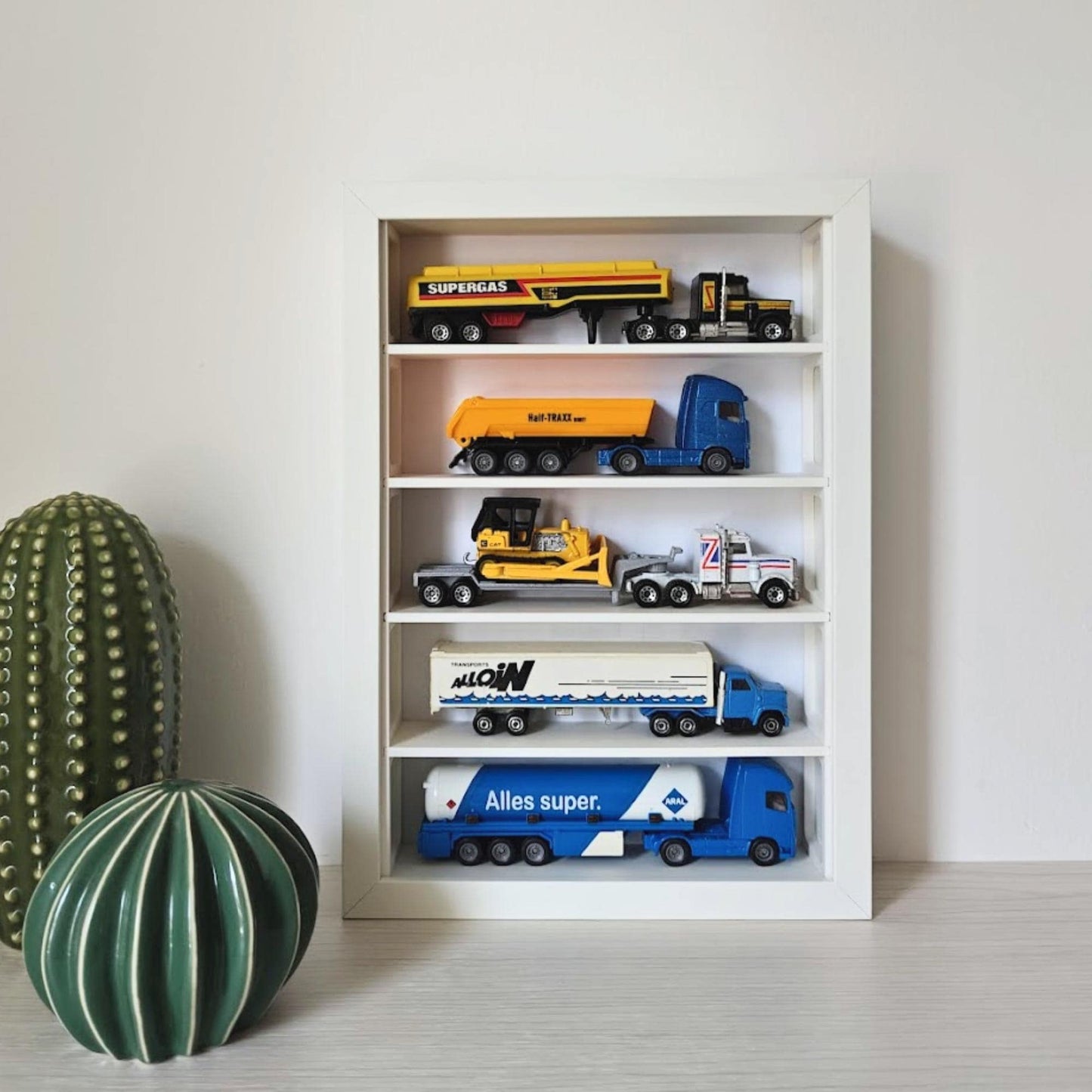 IKEA Sannahed 21×30 cm frame with grid insert displaying 1:64 diecast vehicles