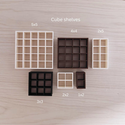 Various miniature cube shelves labeled by grid size (5x5, 4x4, 2x5, 3x3, etc.) in brown, white, and beige colors.