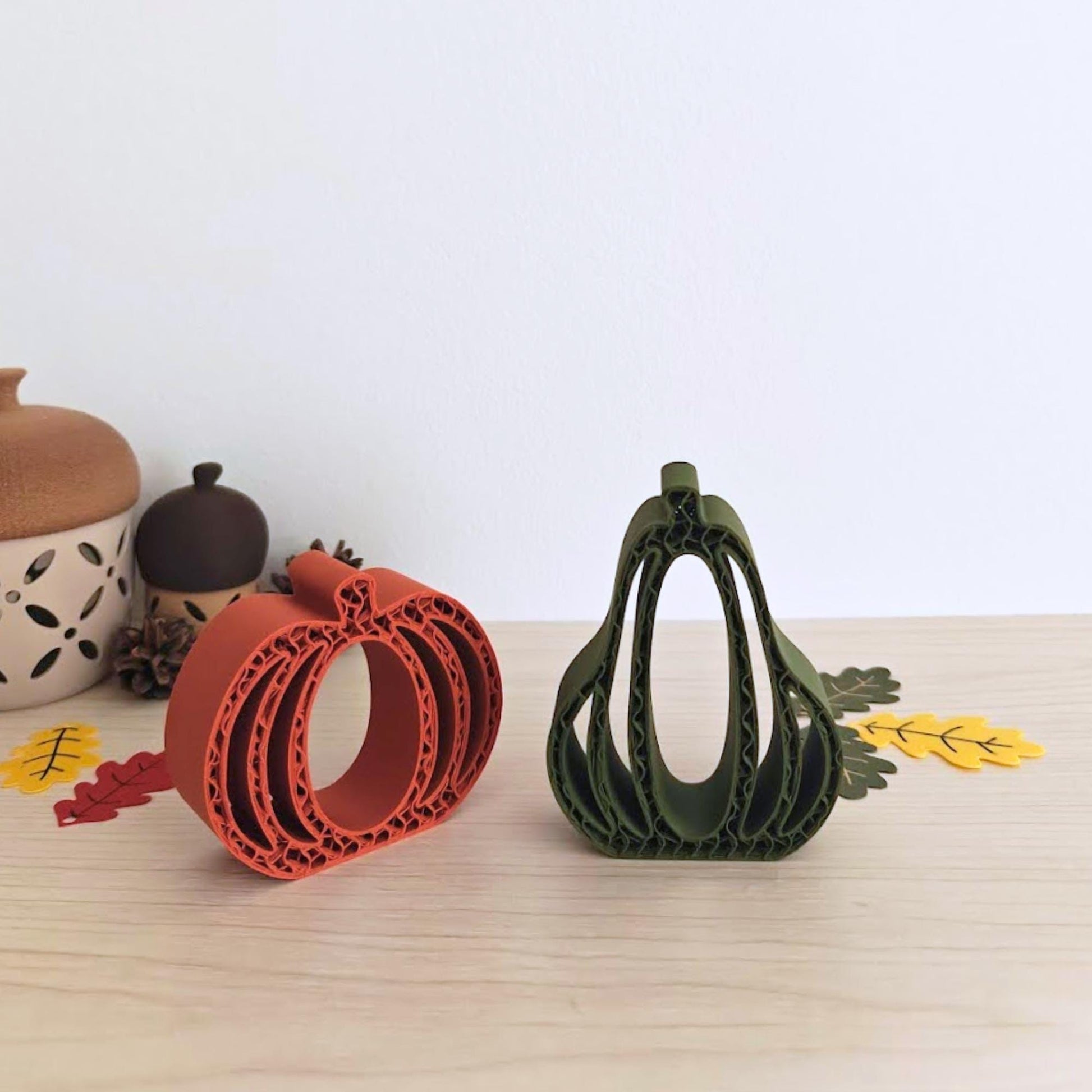 Fall-themed table with 3D-printed pumpkin and gourd, acorns, and autumn leaves arranged decoratively.