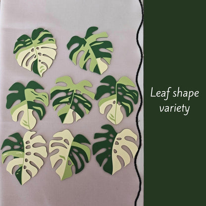 Various Monstera leaf coaster shapes displayed on table.