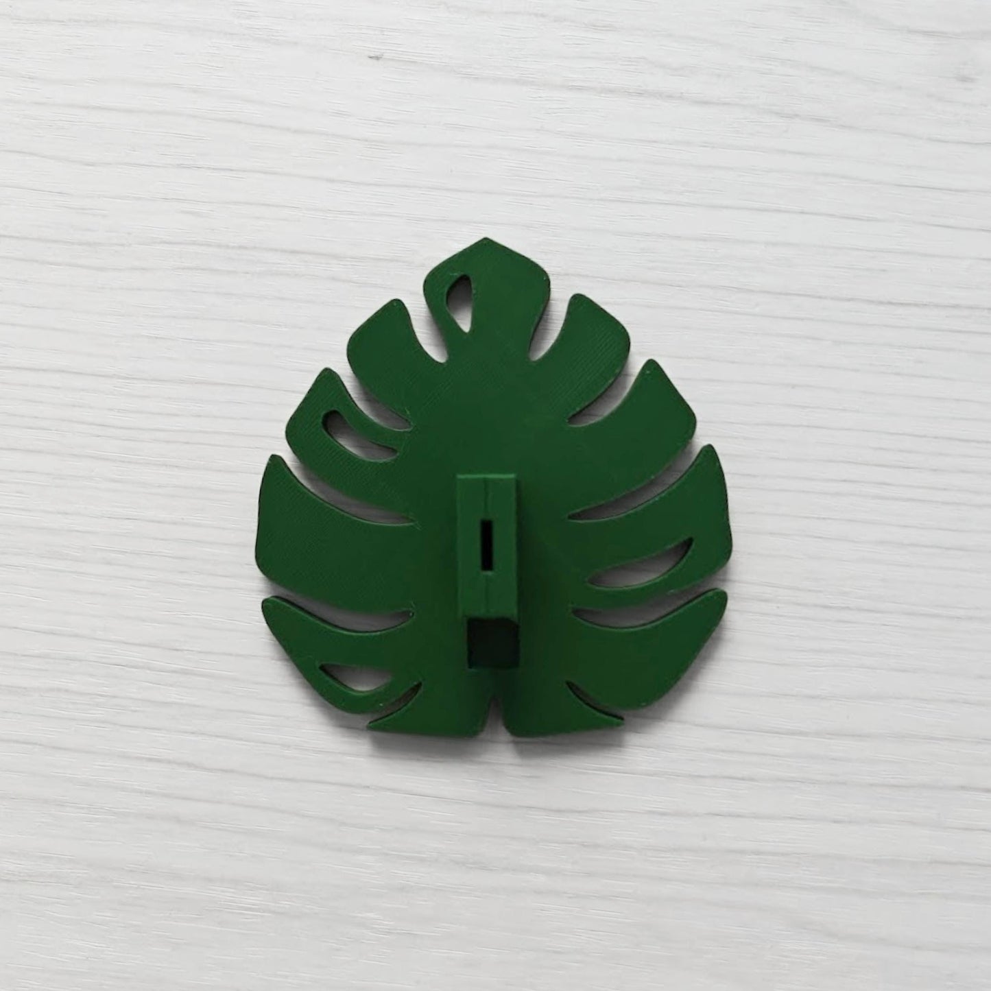 Back view of the Monstera leaf handle with the key cover inserted vertically.