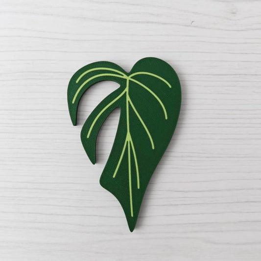 Front view of the Monstera Burle Marx key cover handle for IKEA FABRIKÖR on a light wood background.