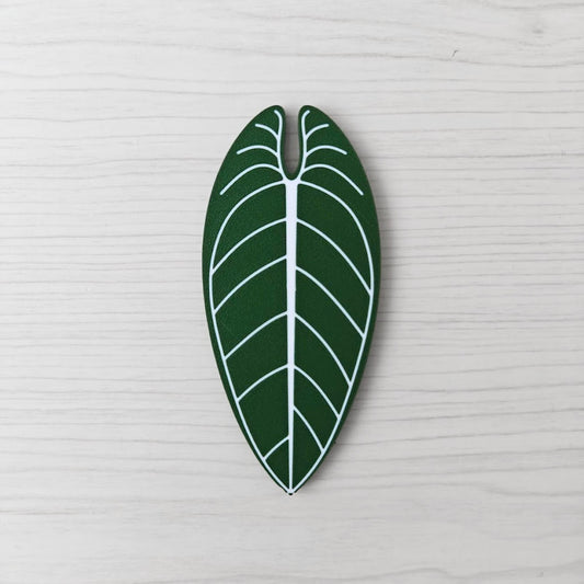 Front view of the Anthurium Warocqueanum key cover handle with white vein detail on a light wood background.