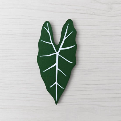 Front view of the solid green Alocasia Frydek key cover handle on a light wood background.