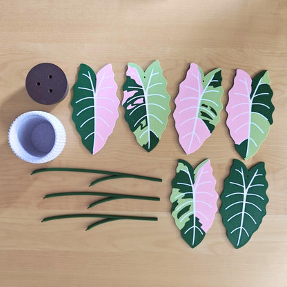 Top view of the full coaster set with holder, showing all leaf coasters and curved support stems laid out separately.