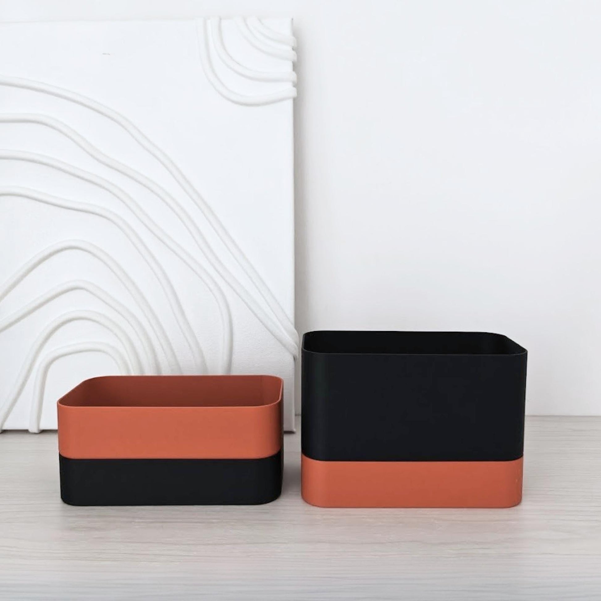 Two rectangular self-watering planters shown side by side in two color combinations on a light surface.