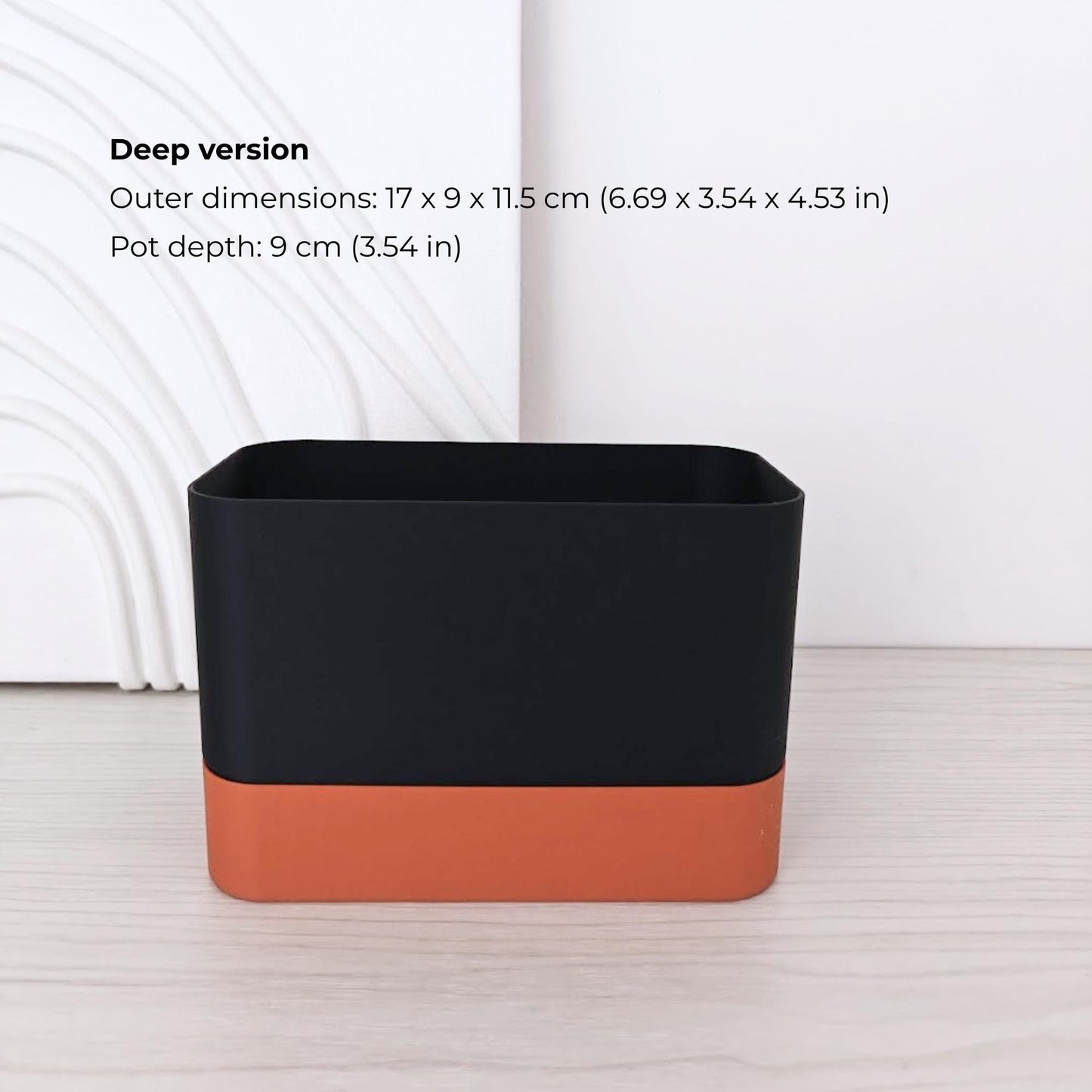 Deep rectangular self-watering planter assembled in terracotta and black.