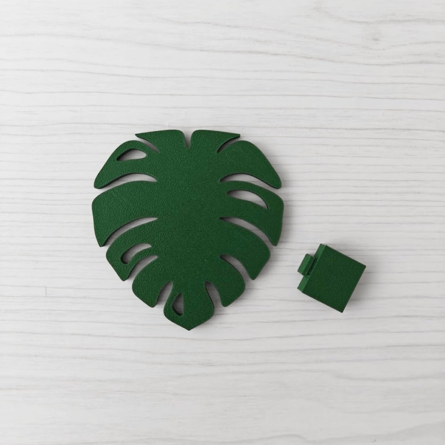 Solid leaf green Monstera leaf handle with the separate green key cover piece shown beside it.