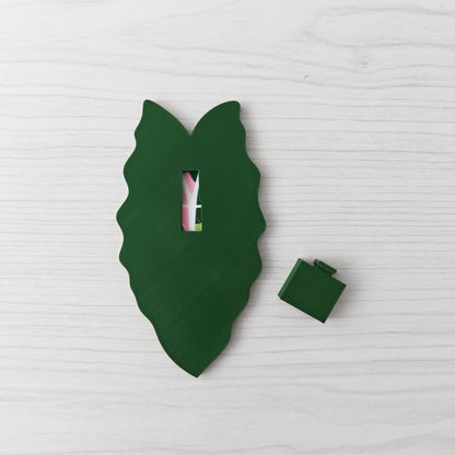 Back view of the variegated handle with the separate green cover piece placed beside it.