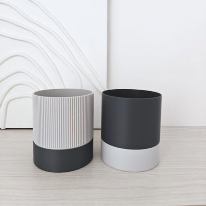 Two self-watering planter design options side by side: ribbed and smooth.