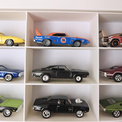 Close-up of Hot Wheels cars arranged in grid compartments
