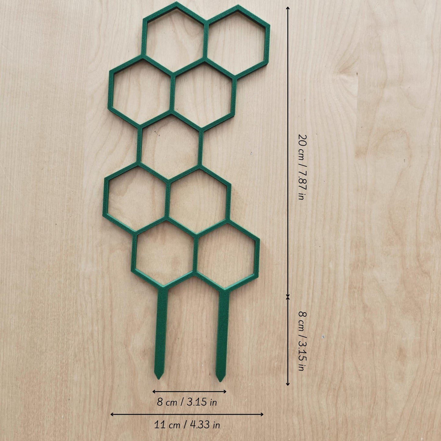 Single short honeycomb trellis segment laid flat on wood surface with marked dimensions
