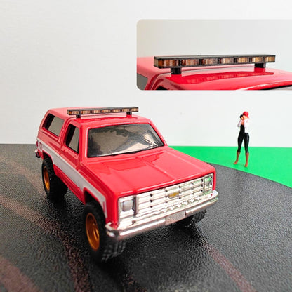 Red diecast SUV with black and transparent roof light bar mounted