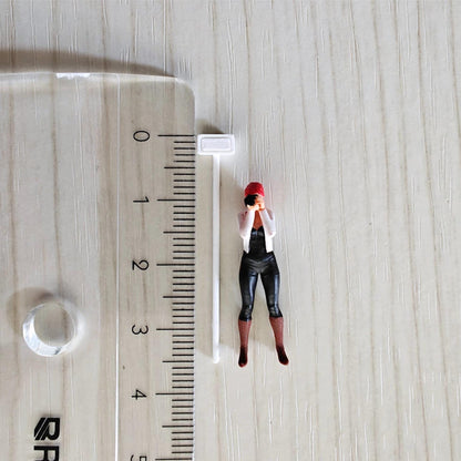 Mini pole floodlight next to ruler and figure for size comparison