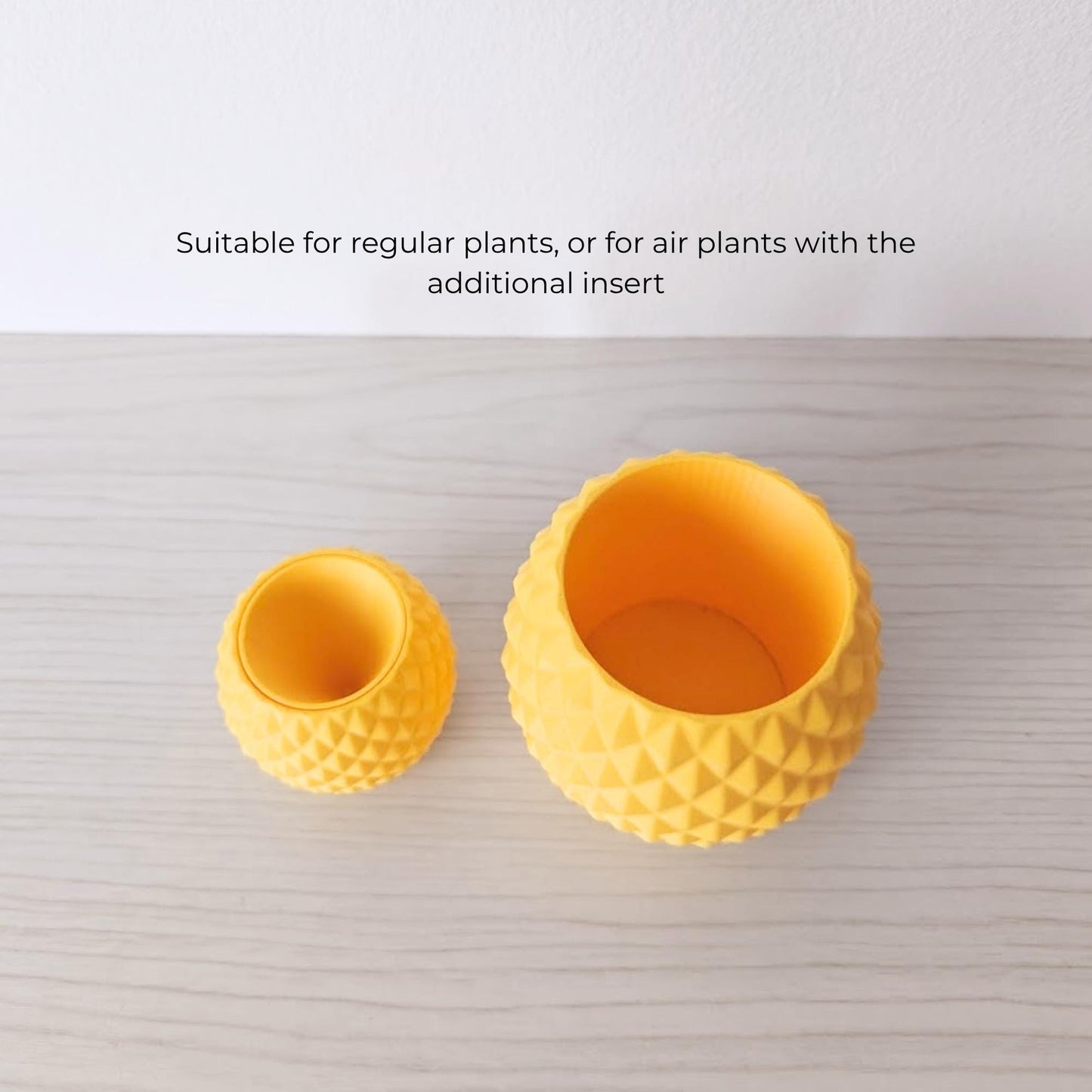 Two pineapple planters in different sizes placed side by side, size comparison display