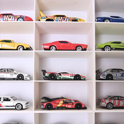 Close-up of Hot Wheels cars arranged in grid compartments