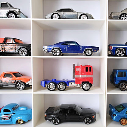 Close-up of Hot Wheels cars arranged in grid compartments