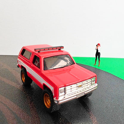Red diecast SUV with black and red roof light bar mounted