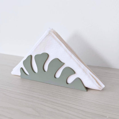 Napkin holder with folded white napkins