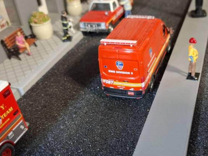 Orange van model from rear angle with roof-mounted emergency light bar