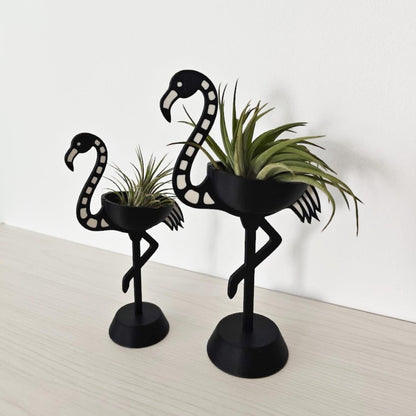 Pair of skeleton flamingo Tillandsia holders shown at an angle, highlighting size difference
