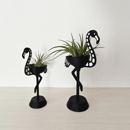 Pair of skeleton flamingo Tillandsia holders shown at an angle, highlighting size difference
