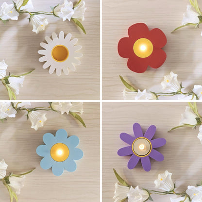 Four different flower tealight holder designs with LED candles lit