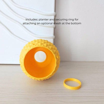 Inverted pineapple planter showing bottom opening and included ring for hanging