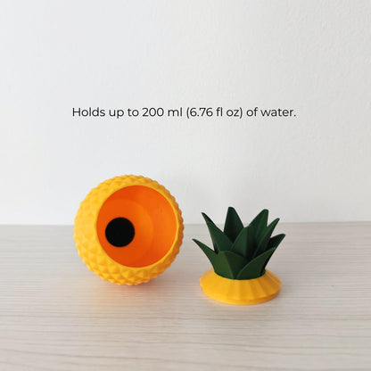 Pineapple watering spike shown open with removable lid and water reservoir capacity information.