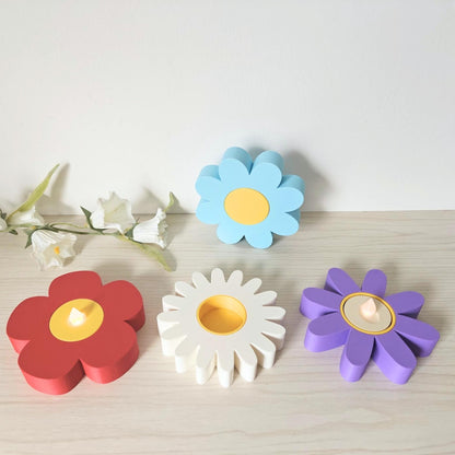 Group of flower tealight holders arranged on a shelf with flowers