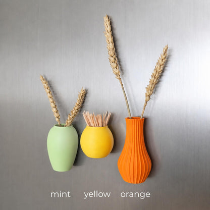 Three mini magnetic vases in various colors.