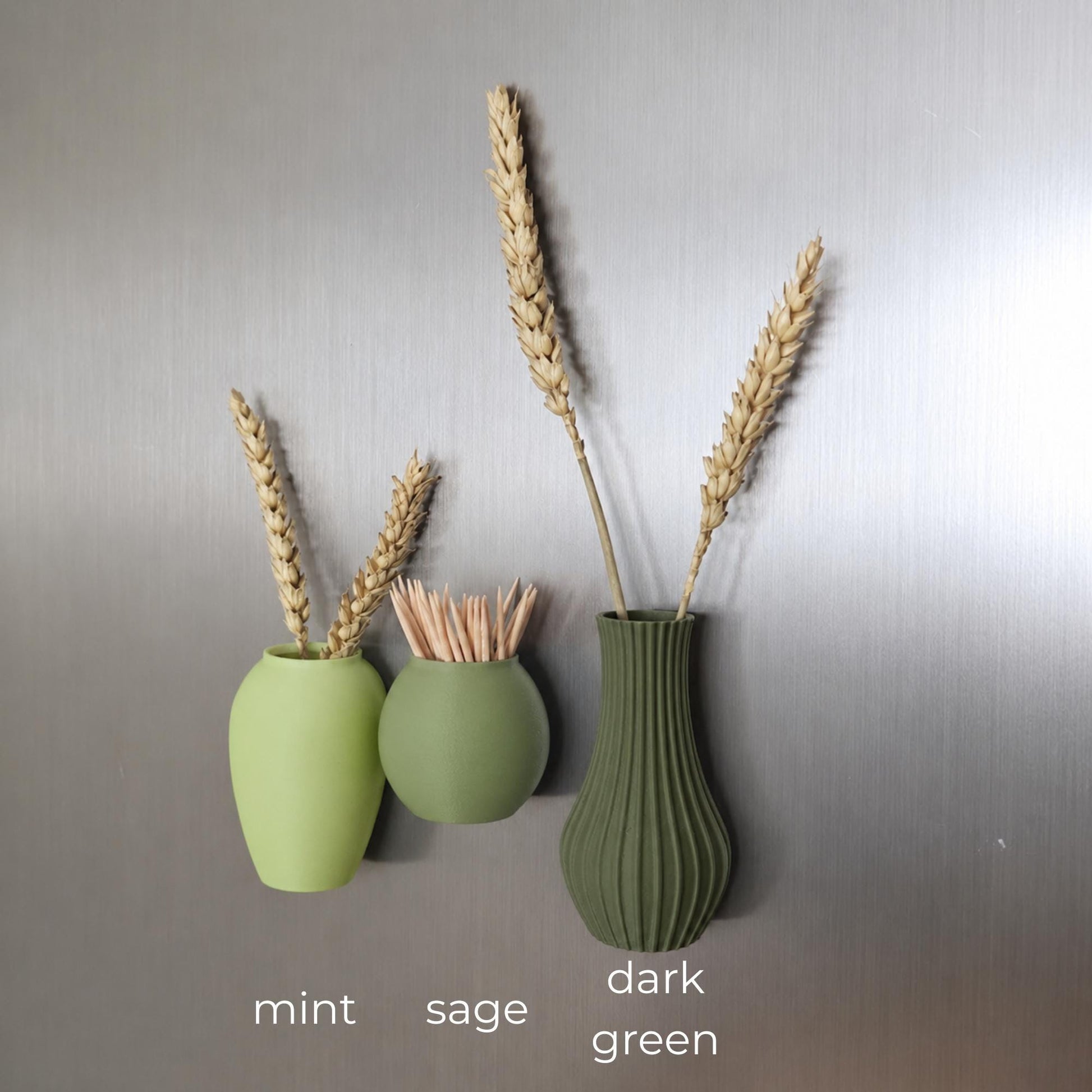 Three mini magnetic vases in various colors.