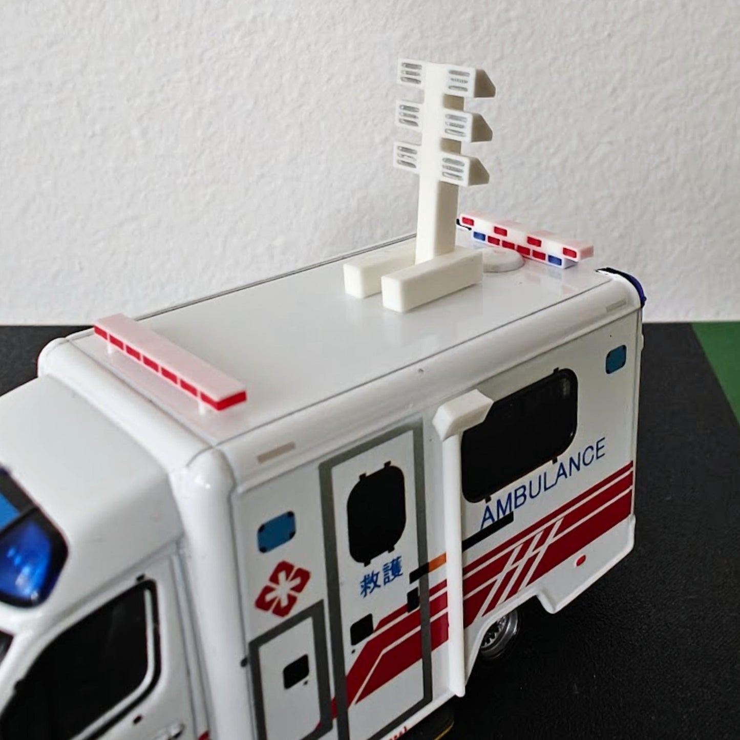 3D printed roof light tower and red roof light accessories mounted on a miniature ambulance