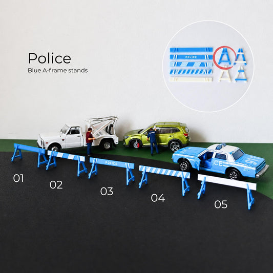 Blue police A-frame barricades and street barriers displayed with tow truck, police car and accident scene
