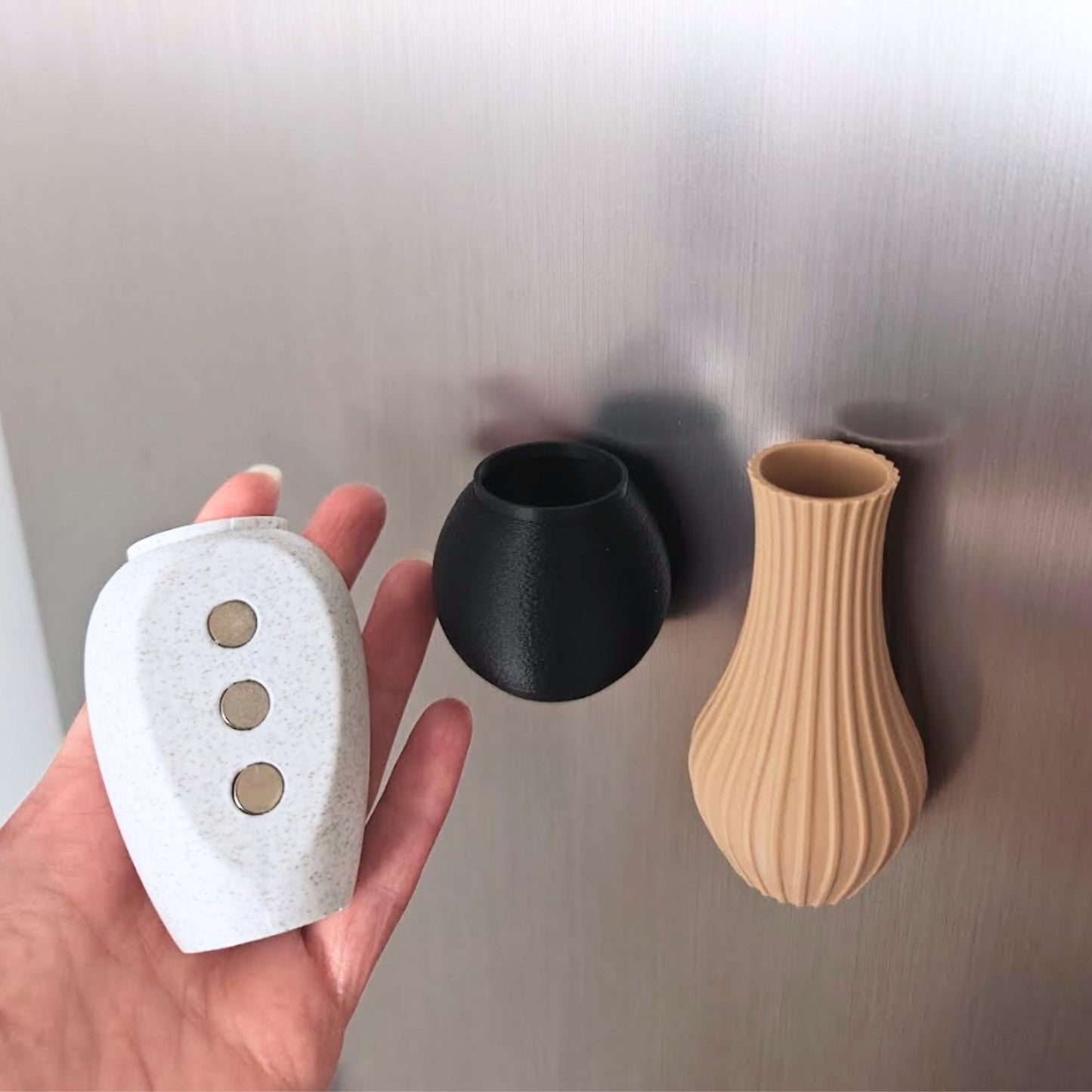 Back view of a white mini magnetic vase showing three round magnets.