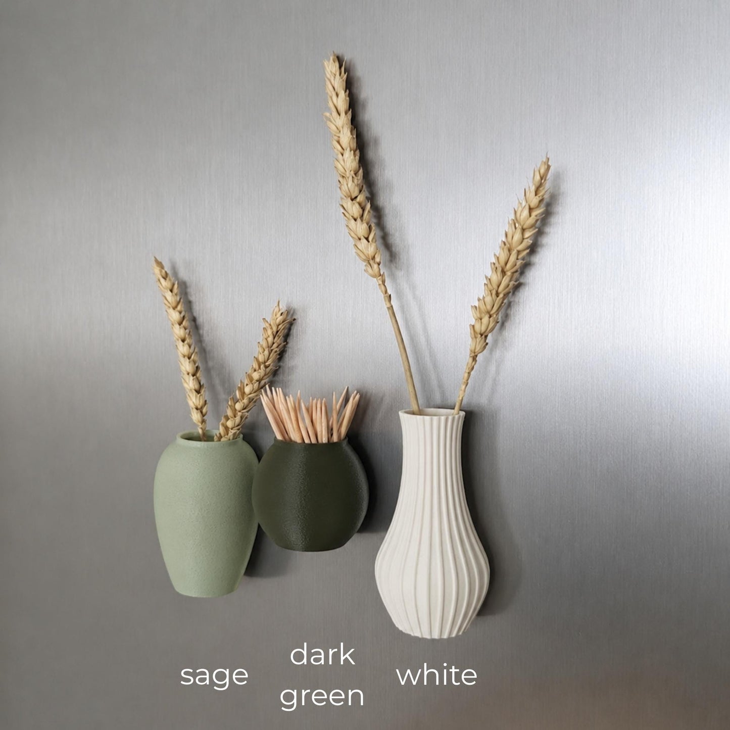Three mini magnetic vases in various colors.