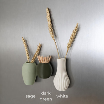 Three mini magnetic vases in various colors.