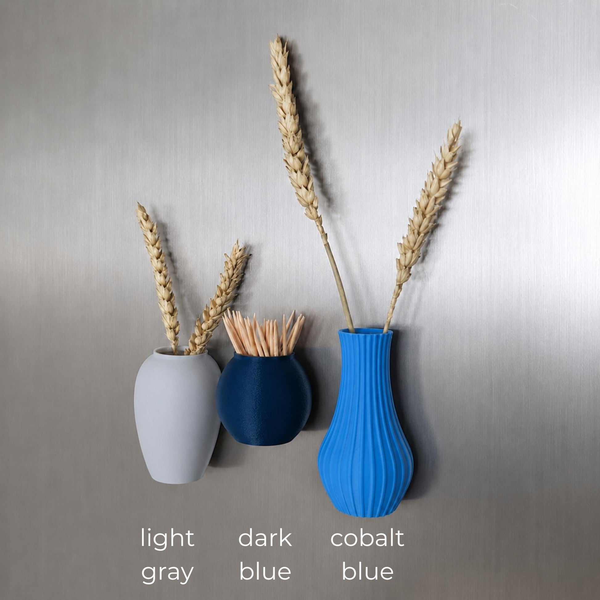 Three mini magnetic vases in various colors.