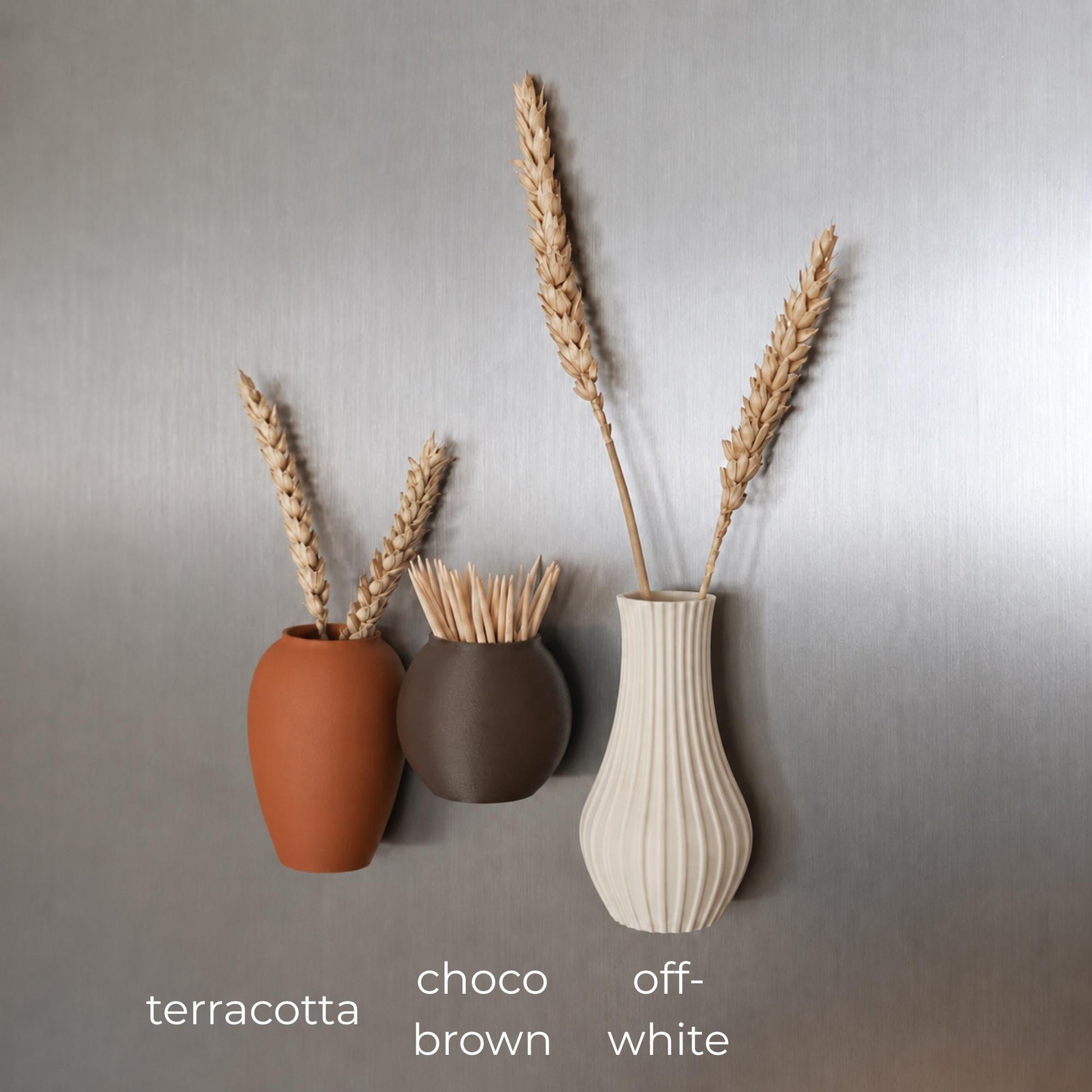 Three mini magnetic vases in various colors.