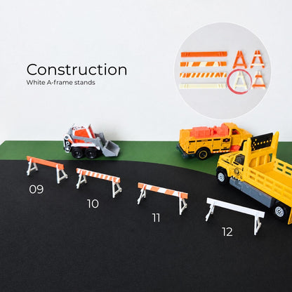 White and orange construction road barriers arranged with miniature construction trucks