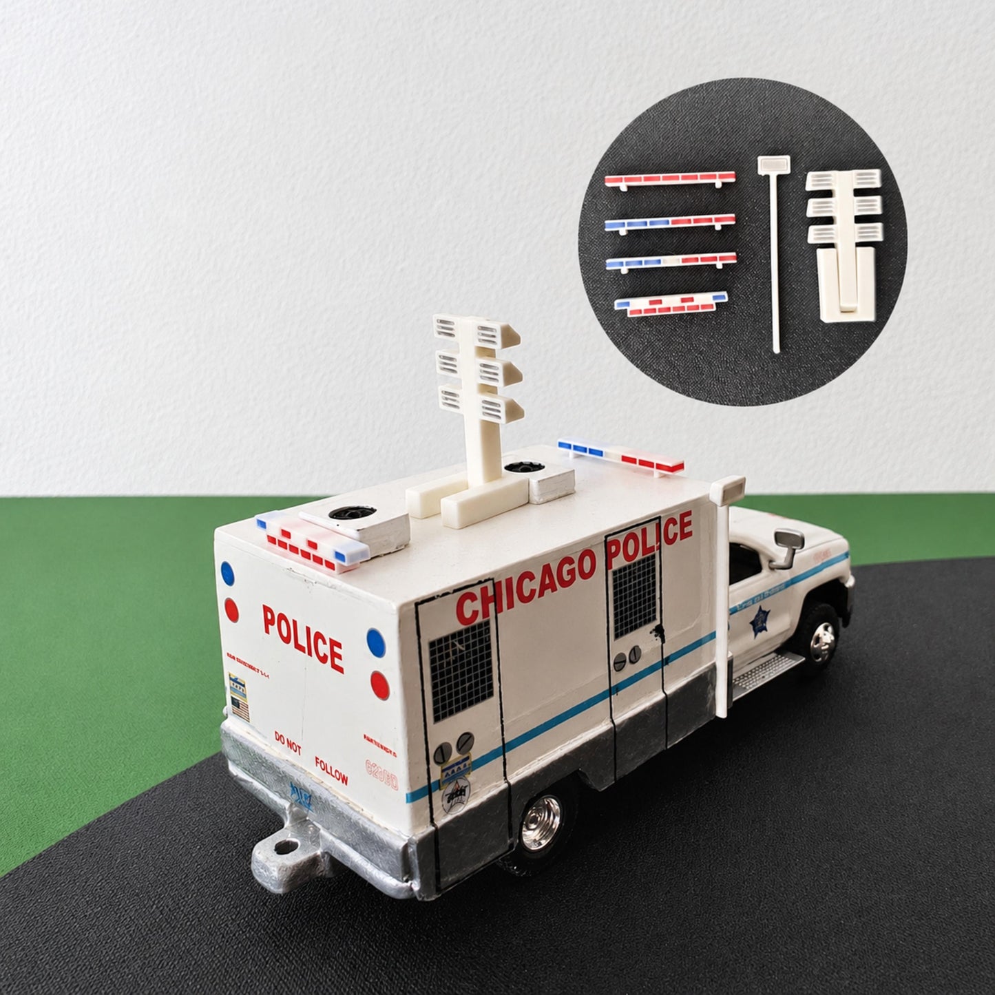 1:64 scale emergency vehicle roof lights and light tower accessories displayed on a miniature police truck